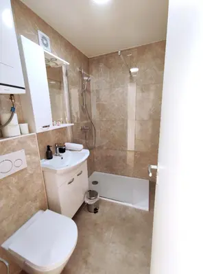 a bathroom with a toilet sink and a shower at Apartment Twin 2 in Ljubljana