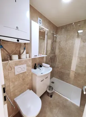 a bathroom with a toilet and a sink and a shower at Apartment Twin 2 in Ljubljana