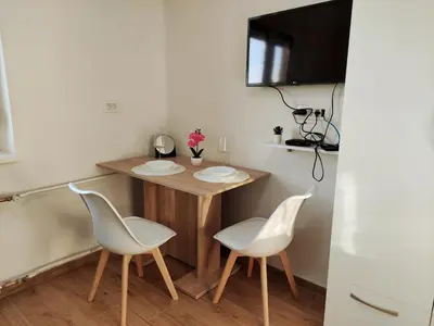 a small kitchen with a table and two chairs at Apartment Twin 2 in Ljubljana