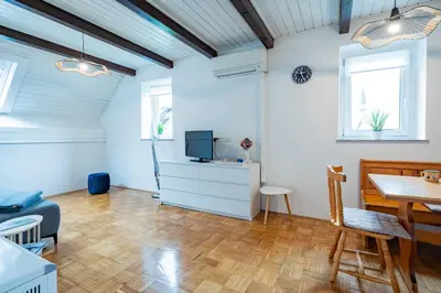 a living room with a tv and a dining room table at Misty May Apartment in Bovec