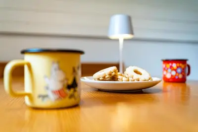 a cup of coffee and a plate of food on a table at Misty May Apartment in Bovec