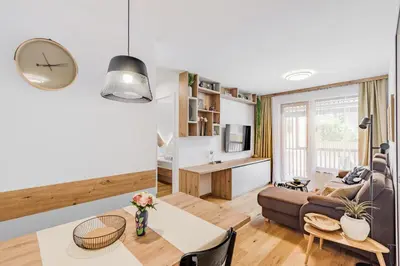 a living room with a couch and a table at Mountain Melody Kranjska Gora in Kranjska Gora