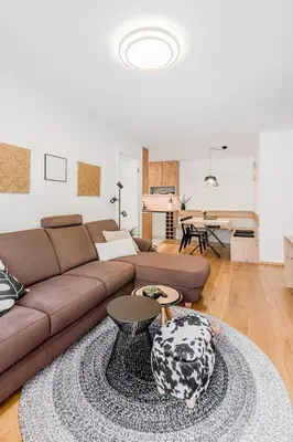 a living room with a couch and a table at Mountain Melody Kranjska Gora in Kranjska Gora