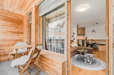 a room with a sliding glass door to a living room at Mountain Melody Kranjska Gora in Kranjska Gora