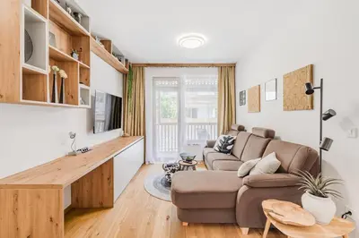 a living room with a couch and a table at Mountain Melody Kranjska Gora in Kranjska Gora
