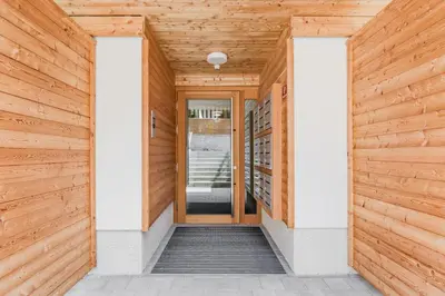 a hallway of a wooden house with a wooden door at Mountain Melody Kranjska Gora in Kranjska Gora