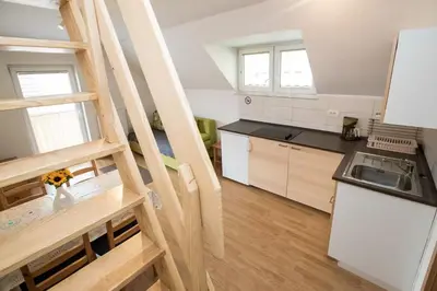 a kitchen with a staircase leading up to a room at Apartmaji Daša & Anže in Bohinj