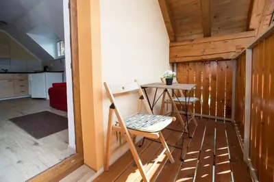a small table and a chair in a room at Apartmaji Daša & Anže in Bohinj