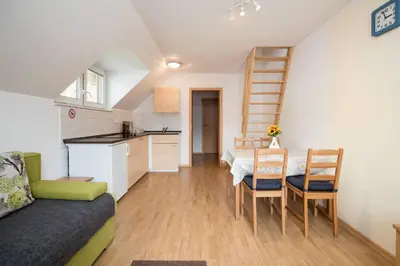 a kitchen and a dining room with a table and chairs at Apartmaji Daša & Anže in Bohinj