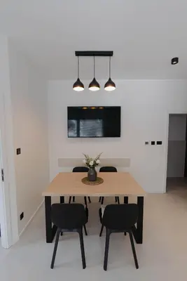 a dining room with a table and two chairs at ALPEART GOZD MARTULJEK HOLIDAY unit in Kranjska Gora