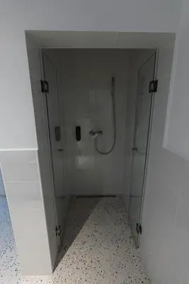 a shower with a glass door in a bathroom at ALPEART GOZD MARTULJEK HOLIDAY unit in Kranjska Gora