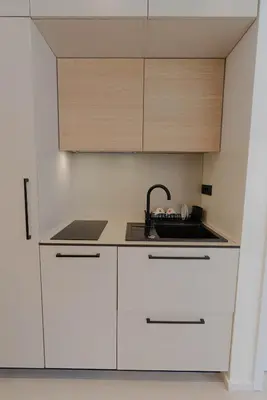 a kitchen with white cabinets and a sink at ALPEART GOZD MARTULJEK HOLIDAY unit in Kranjska Gora