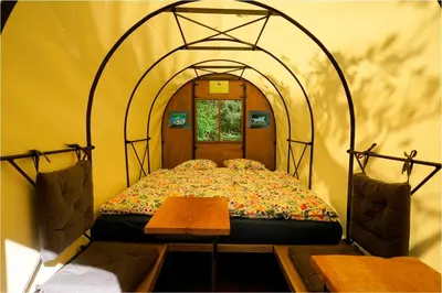 a bed in a room with an arched doorway at Glamping Tlaka in Gornji Grad