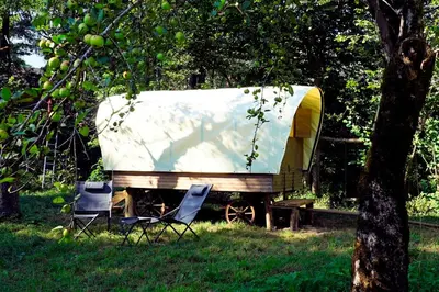 a boat sitting on a trailer in the grass at Glamping Tlaka in Gornji Grad