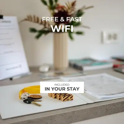 a sign that reads free and fast wifi on a desk at Peaceful City Stay in Ljubljana