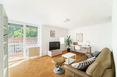 a living room with a couch and a tv at Peaceful City Stay in Ljubljana