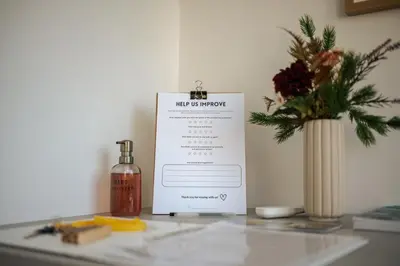 a sign on a counter with a bottle and a vase at Peaceful City Stay in Ljubljana