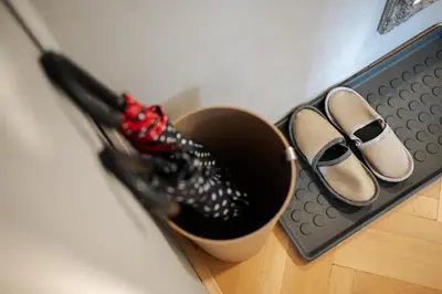 a pair of shoes are next to a pot with an umbrella at Peaceful City Stay in Ljubljana