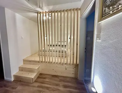 a room with a staircase with a bench in it at Apartma Vrbnjak in Bohinj