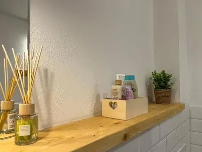 a wooden shelf with products on it in a bathroom at Apartma Vrbnjak in Bohinj