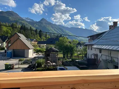 a view of a town with mountains in the background at Apartma Vrbnjak in Bohinj