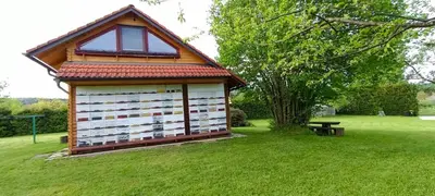 a small shed in a field with a picnic table at Village Vista in Rob