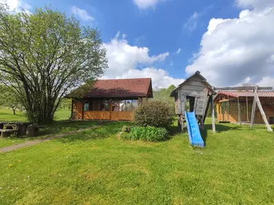 a house with a blue slide in the yard at Village Vista in Rob