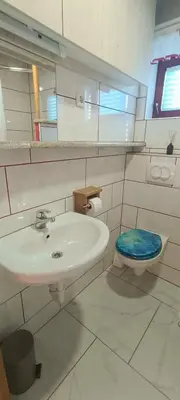 a bathroom with a sink and a toilet at Village Vista in Rob