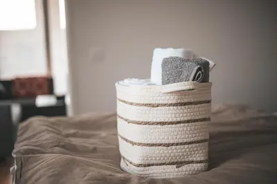 a stack of towels sitting on top of a bed at Stork's Nest - Moravske Toplice in Moravske Toplice