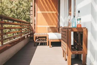 a balcony with a table and a bottle of wine at Stork's Nest - Moravske Toplice in Moravske Toplice