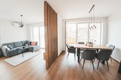 a dining room and living room with a table and chairs at Stork's Nest - Moravske Toplice in Moravske Toplice