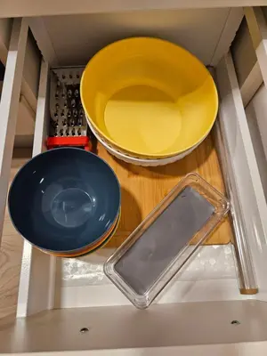 two plates and bowls on a shelf in a kitchen at Apartma Zora in Bovec