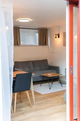 a living room with a couch and a table at Apartment Bohinj with excellent location in Bohinj
