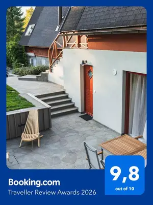 a house with a red door and a patio at Apartment Bohinj with excellent location in Bohinj
