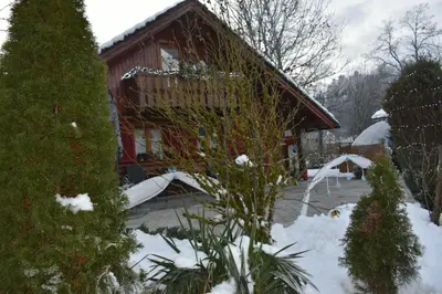 a house with snow on the ground in front of it at Počitniška hiša z dvema spalnicama Sauna & Jacuzzi in Gorica pri Slivnici