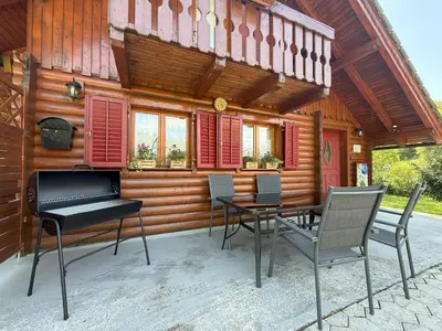 a patio with a table and chairs in front of a house at Počitniška hiša z dvema spalnicama Sauna & Jacuzzi in Gorica pri Slivnici