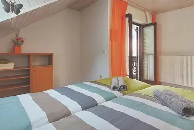 a bedroom with a bed with towels on it at Apartment Erika in Idrija