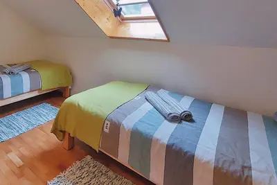 a bedroom with two beds and a window at Apartment Erika in Idrija
