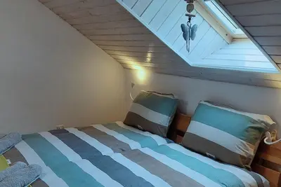 a bedroom with a bed and a skylight at Apartment Erika in Idrija