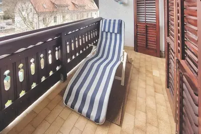 a blue and white bench on a balcony at Apartment Erika in Idrija