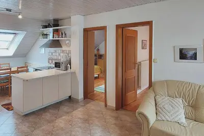a kitchen and living room with a couch and a table at Apartment Erika in Idrija