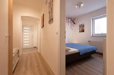 a small bedroom with a bed and a window at Apartma Seničica in Ljubljana