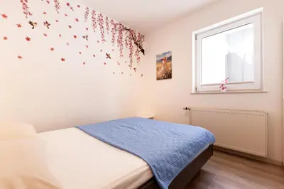 a bedroom with a bed and a window at Apartma Seničica in Ljubljana