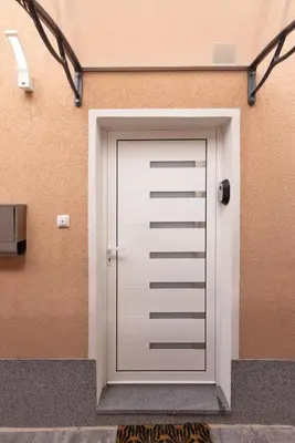 a white garage door on the side of a building at Apartma Seničica in Ljubljana