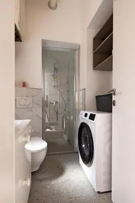 a bathroom with a washing machine and a toilet at Apartma Seničica in Ljubljana