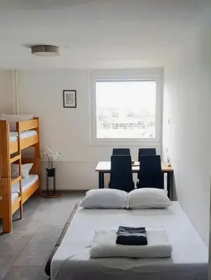 a bedroom with a bed and a table and chairs at Renovated Apartment for Four in Ljubljana