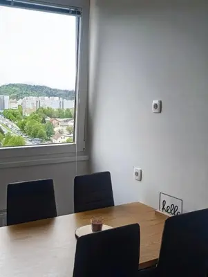 a conference room with a table and chairs and a window at Renovated Apartment for Four in Ljubljana