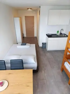 a room with two beds and a kitchen at Renovated Apartment for Four in Ljubljana