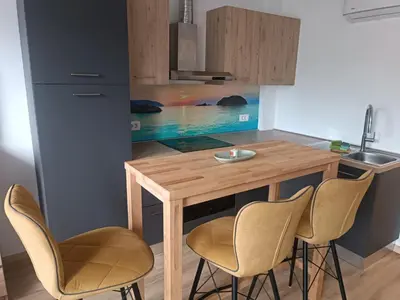 a kitchen with a wooden table and chairs at CoCo Apartment in Ljubljana