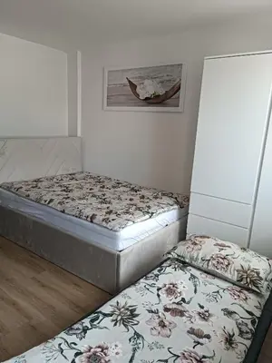 two twin beds in a room with a picture on the wall at CoCo Apartment in Ljubljana